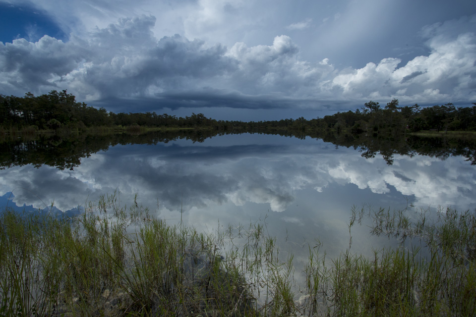 burns lake at dusk with passing storm