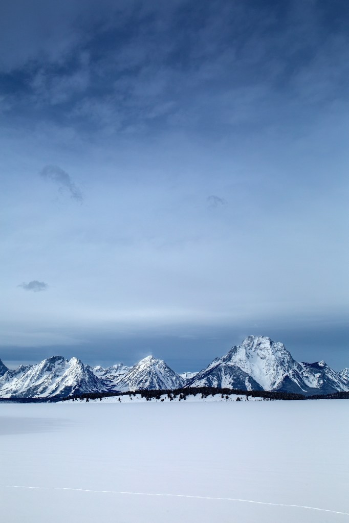 Snow covered Tetons form a frozen Jackson Lake in Grand Teton National Park, WY