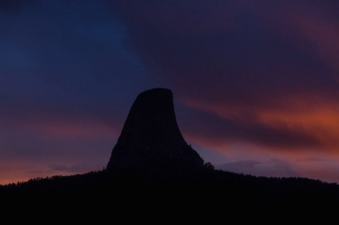dramatic sunset over Devils tower national monument, WY