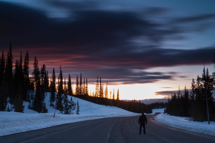 A man watches sunrise on Togwotee pass