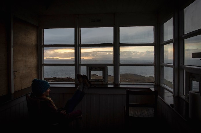 Ellen Slaton gazes out at the view of the Sunset, North Sea, and Isle of Harris
