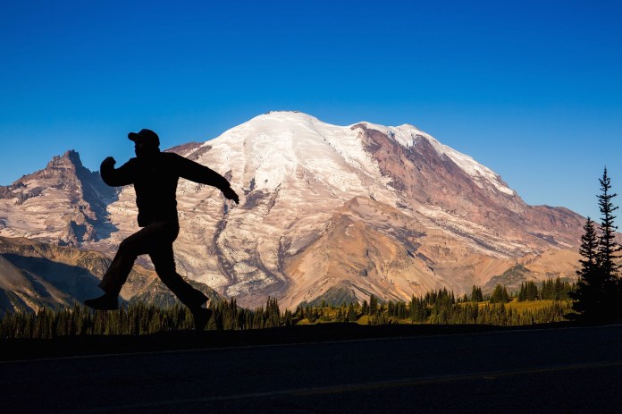 silhouette of a man in front of Mt. Rainier