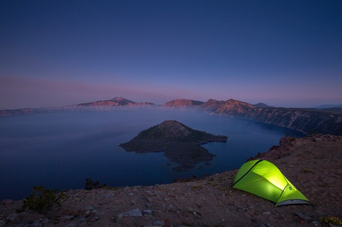 Lit tent on the rim at Crater Lake