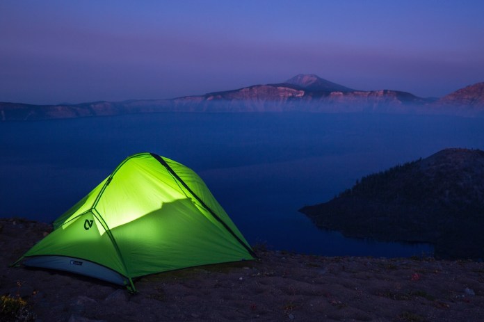 Lit tent on the rim at Crater Lake