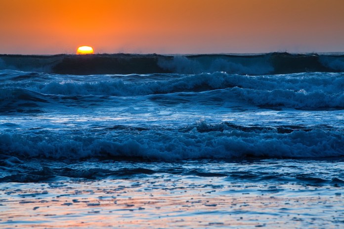 Dusk falls on the Pacific surf at Wilson Creek Beach