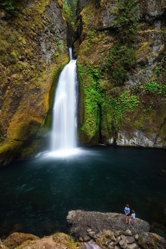 People admiring the majesty of Wahclella Falls