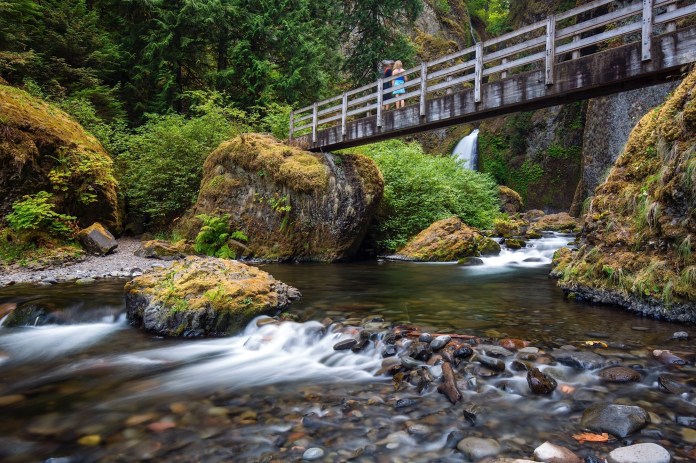People admiring the majesty of Wahclella Falls