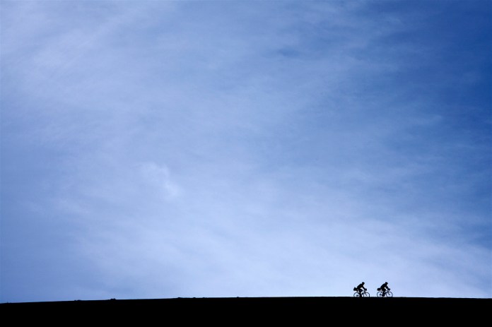 silhouetted cyclists on trail ridge road, Rocky Mountain National Park, CO