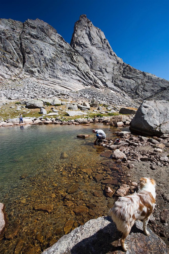 A man washes his face at Cirque Lake